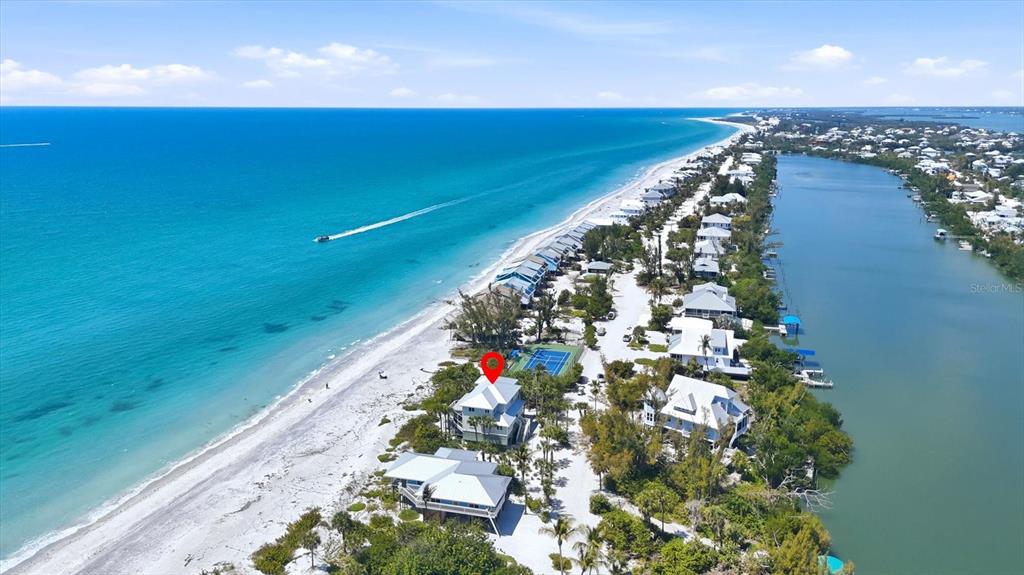 An aerial view shows a beachfront house with a red location pin near the ocean — 400 S GULF BOULEVARD, PLACIDA, FL