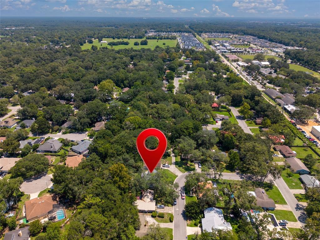 An aerial view shows a residential neighborhood with a red location pin over a house — 8114 SW 12TH PLACE, GAINESVILLE, FL