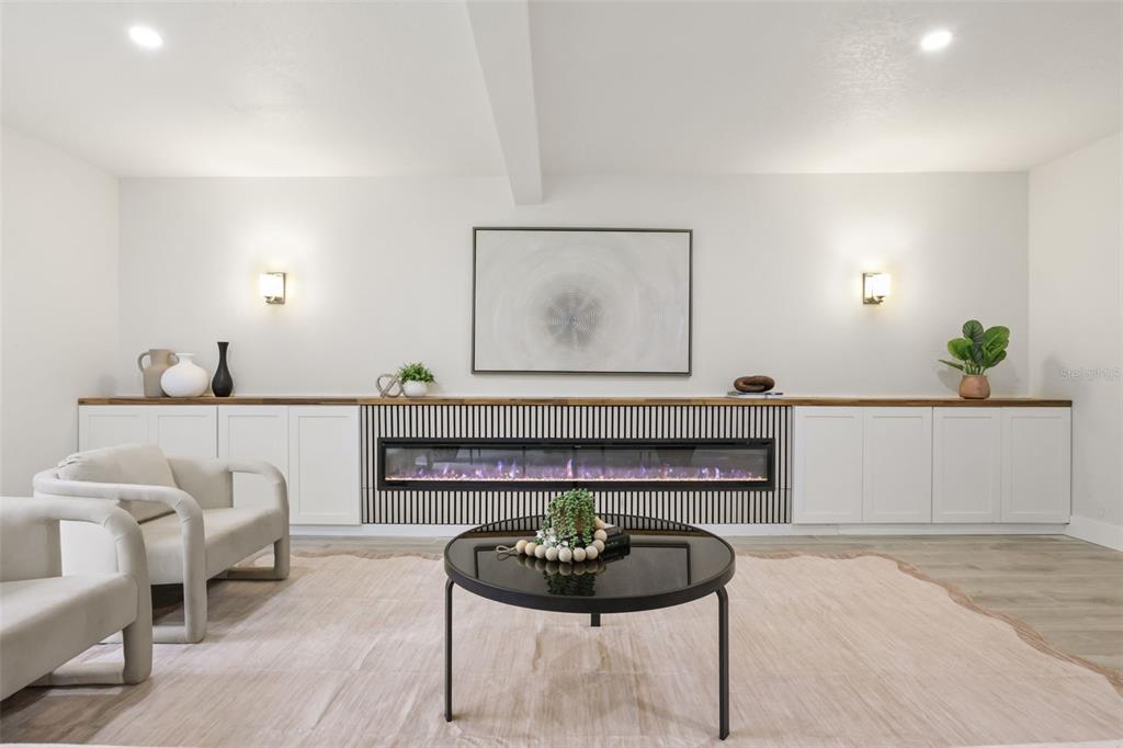 A white galley kitchen features shaker-style cabinets, quartz countertops, a gold faucet, and wood-look flooring — 724 MONMOUTH WAY, WINTER PARK, FL