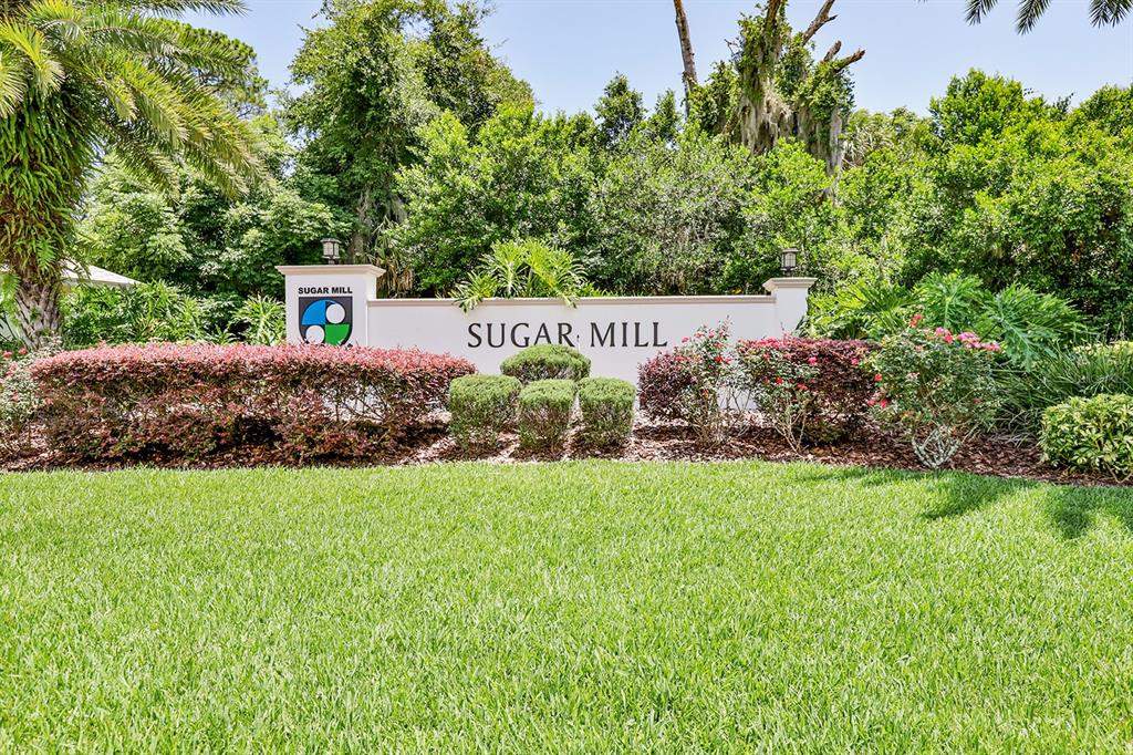 An aerial view shows a vacant residential lot situated between a house and trees — 441 SWEET BAY AVENUE, NEW SMYRNA BEACH, FL