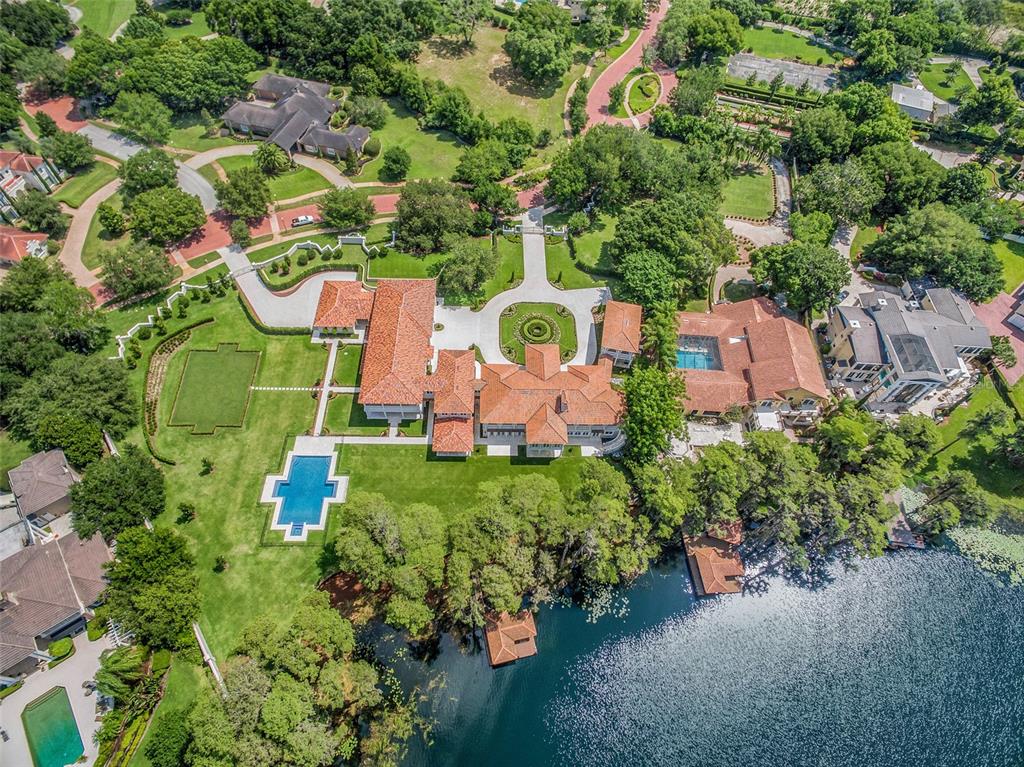 An aerial view shows a large estate with a red-tiled roof, pool, and lakefront access — 12488 PARK AVENUE, WINDERMERE, FL