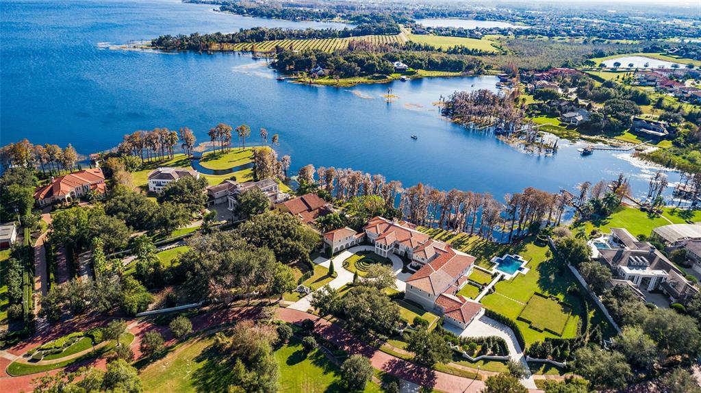 An aerial view shows a large waterfront estate with a pool and landscaped grounds — 12488 PARK AVENUE, WINDERMERE, FL