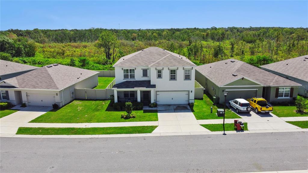 An aerial view of a two-story suburban house with a white exterior and attached garage — 270 MEADOWBROOK BOULEVARD, WINTER HAVEN, FL