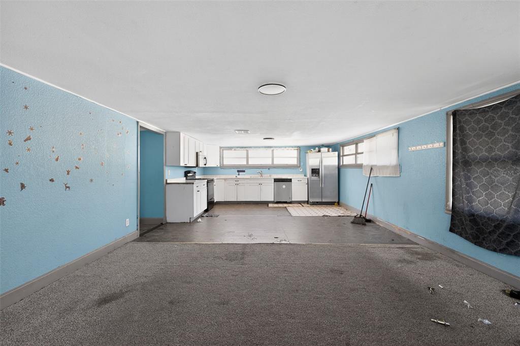A room with light blue walls, purple trim, wood-look flooring, and two open closets — 108 EARL AVENUE, AUBURNDALE, FL