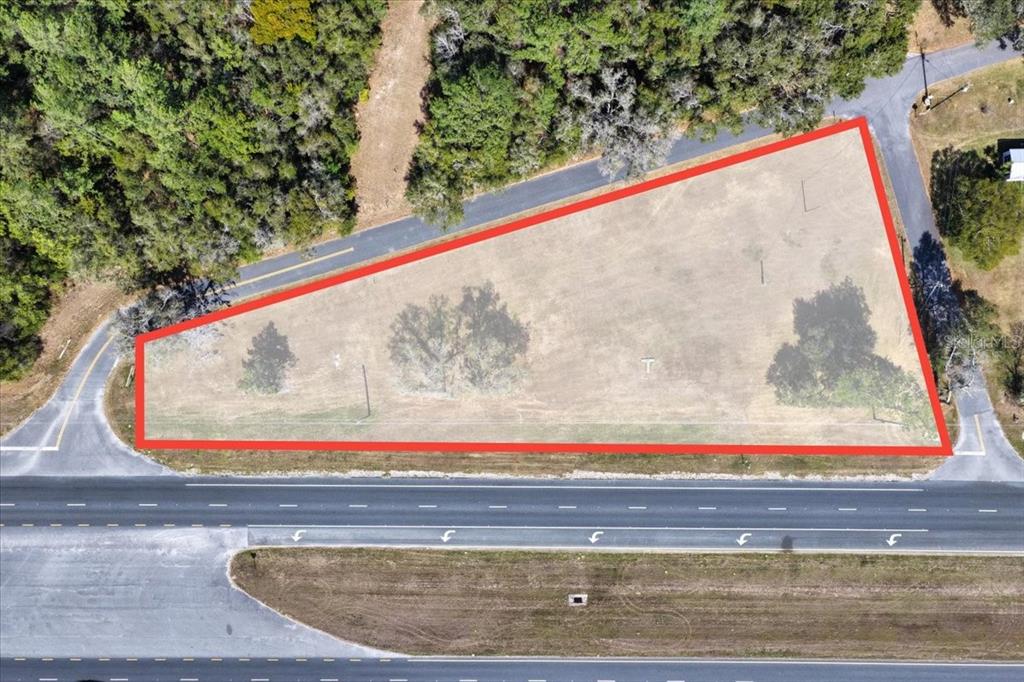 An aerial view shows a triangular, undeveloped plot of land bordered by roads — 18450 NE 40TH STREET, WILLISTON, FL