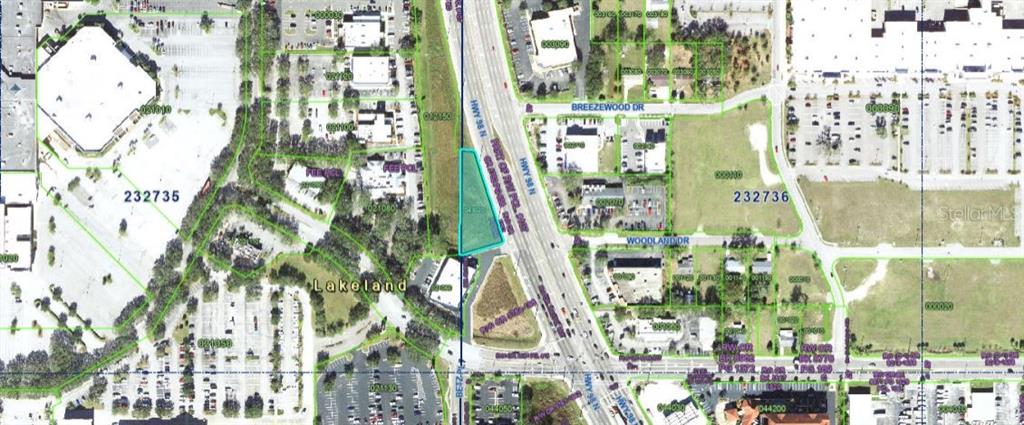 This is an aerial map showing a highlighted parcel of land located along a highway — US-98, LAKELAND, FL