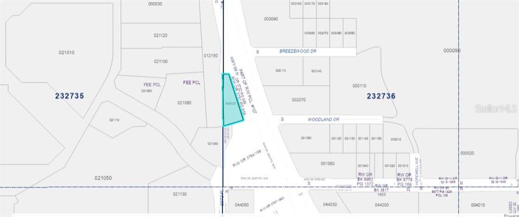 This is a property tax map showing a highlighted parcel of land near a road intersection — US-98, LAKELAND, FL