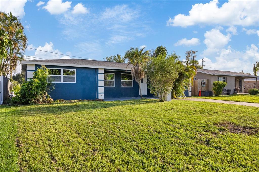 A blue single-story house with a large front lawn and a palm tree — 2698 46TH AVENUE N, ST PETERSBURG, FL