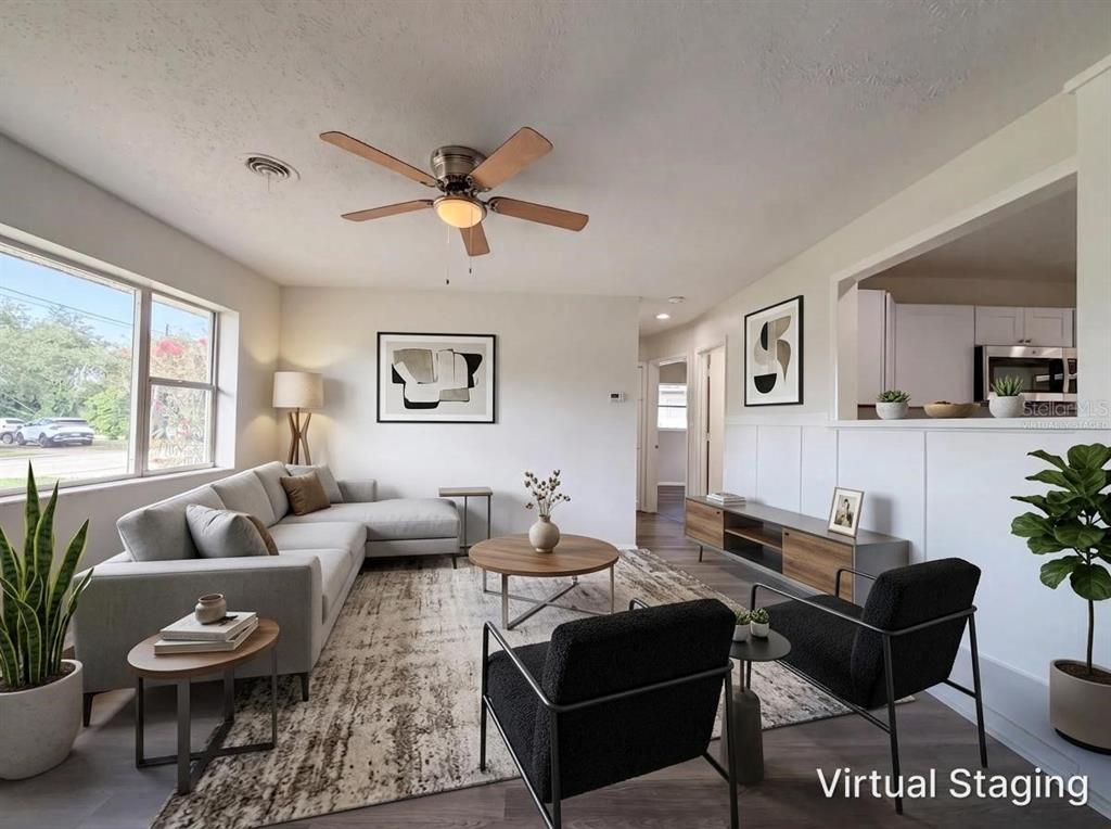 A living room with a sectional sofa, two black chairs, and a ceiling fan — 1516 2ND AVENUE E, BRADENTON, FL