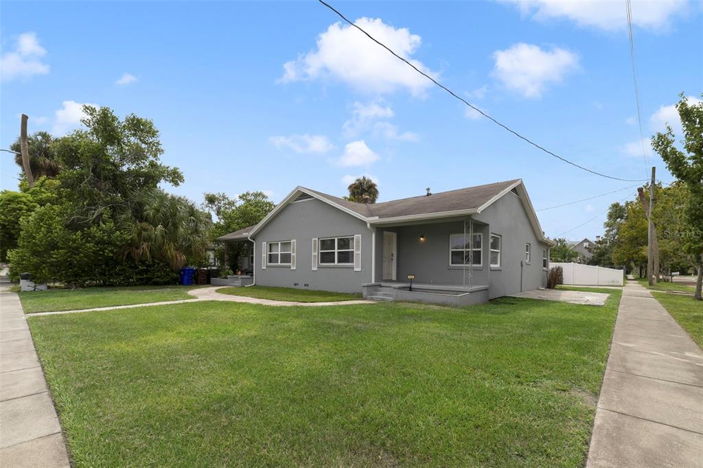 A gray single-story house with a front porch and a sidewalk on a grassy lot — 524 & 526 SUMNER STREET, KISSIMMEE, FL