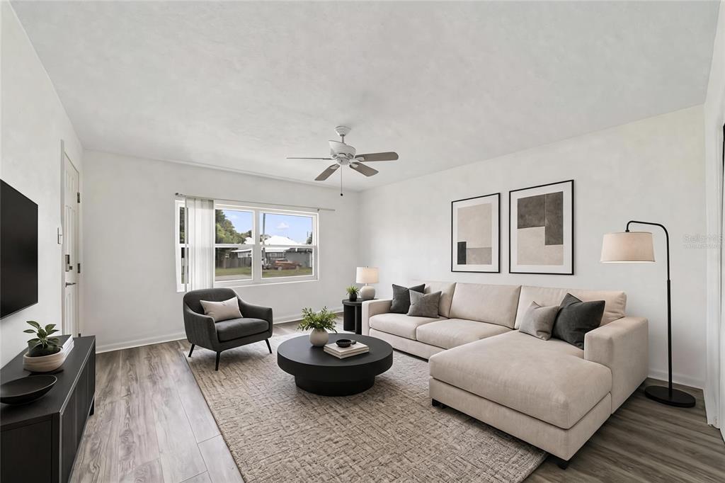 A living room features a beige sectional sofa, a dark armchair, and light wood flooring — 524 & 526 SUMNER STREET, KISSIMMEE, FL