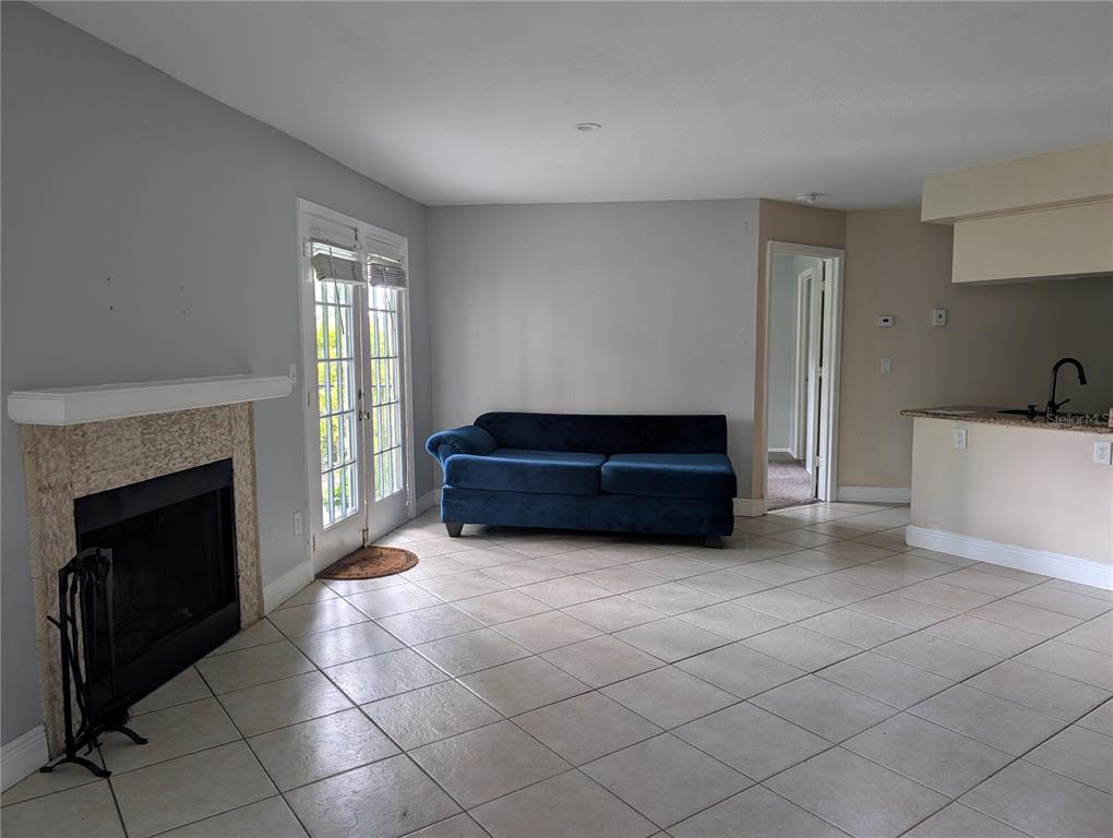 A wooden walkway leads to a covered gazebo overlooking a calm lake surrounded by trees — 2550 N ALAFAYA TRAIL UNIT 12105, ORLANDO, FL