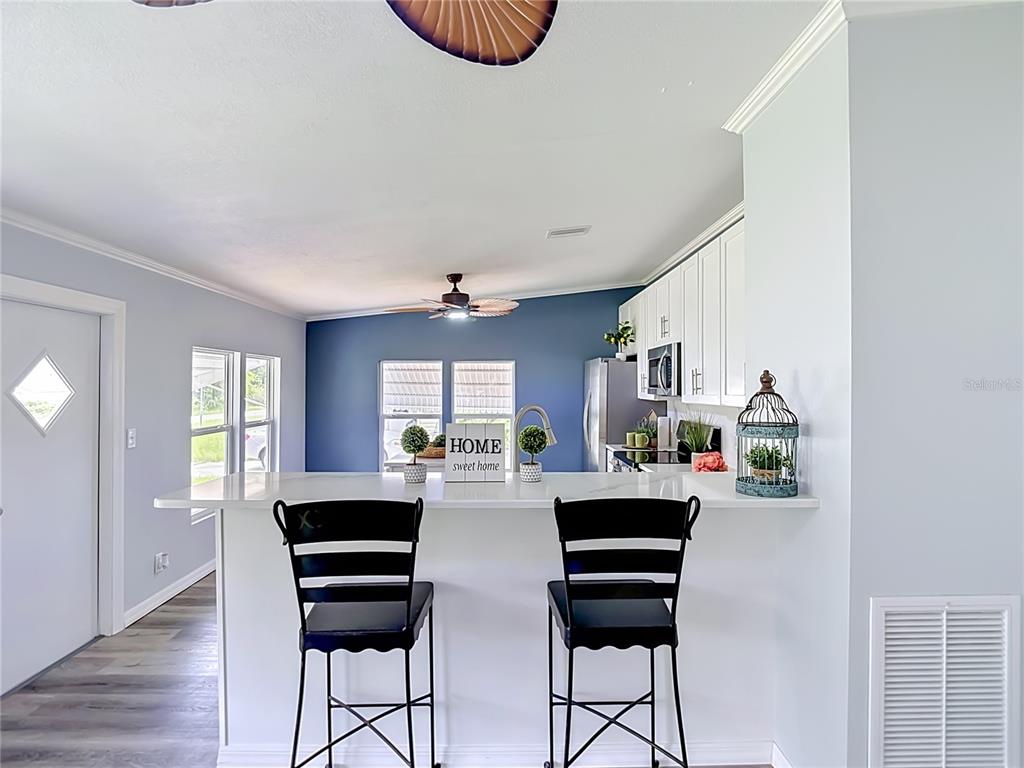 An aerial view shows a house with a gray roof, a driveway, and a large yard — 12331 PARKWOOD STREET, HUDSON, FL