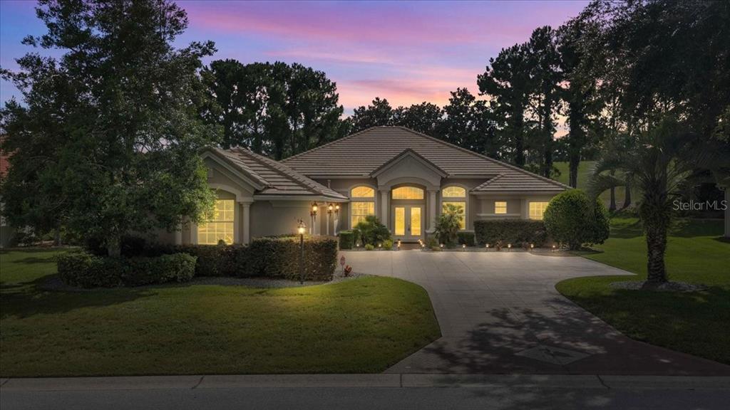 A single-story house with a tiled roof and paved driveway at dusk — 1861 N EAGLE CHASE DRIVE, HERNANDO, FL