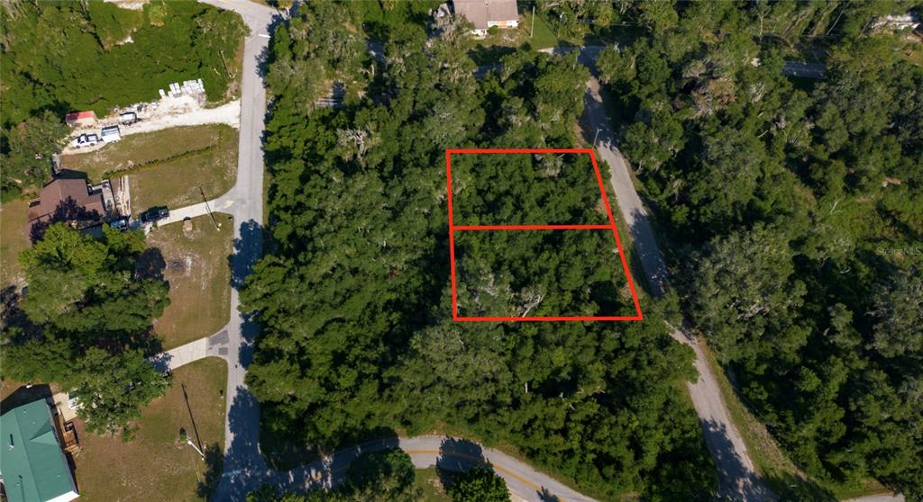 An aerial view shows two adjacent wooded residential lots outlined in red — 4374 E MATE LANE, HERNANDO, FL