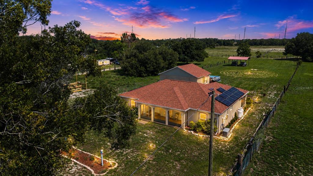 An aerial view shows a house with a red roof, solar panels, and a large yard — 13522 COUNTY ROAD 672 HIGHWAY, RIVERVIEW, FL