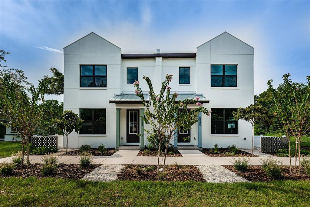 An aerial view shows a vacant lot situated between a modern duplex and a street — 5964 CENTRAL AVENUE, NEW PORT RICHEY, FL