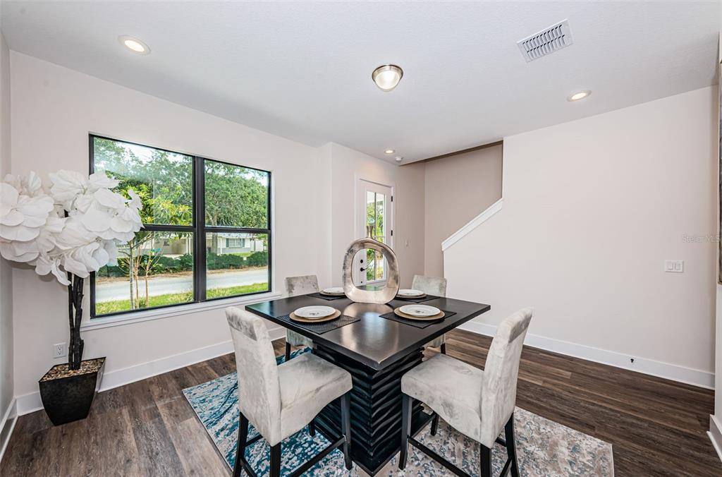 An aerial view shows a two-story house next to a road intersection with crosswalks — 5964 CENTRAL AVENUE, NEW PORT RICHEY, FL