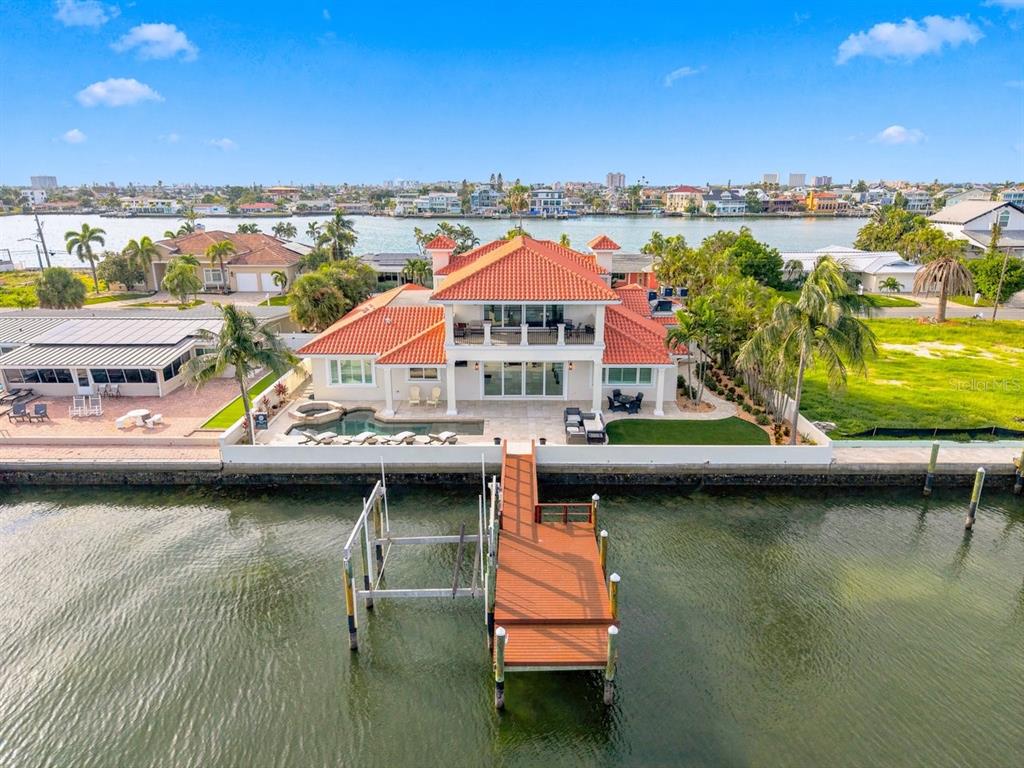 An aerial view of a waterfront house with a red tile roof and private dock — 504 55 TH AVENUE, ST PETE BEACH, FL