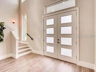 A two-story modern house features a blue front door, gray accents, and a covered porch — 200 E GRANT STREET, ORLANDO, FL