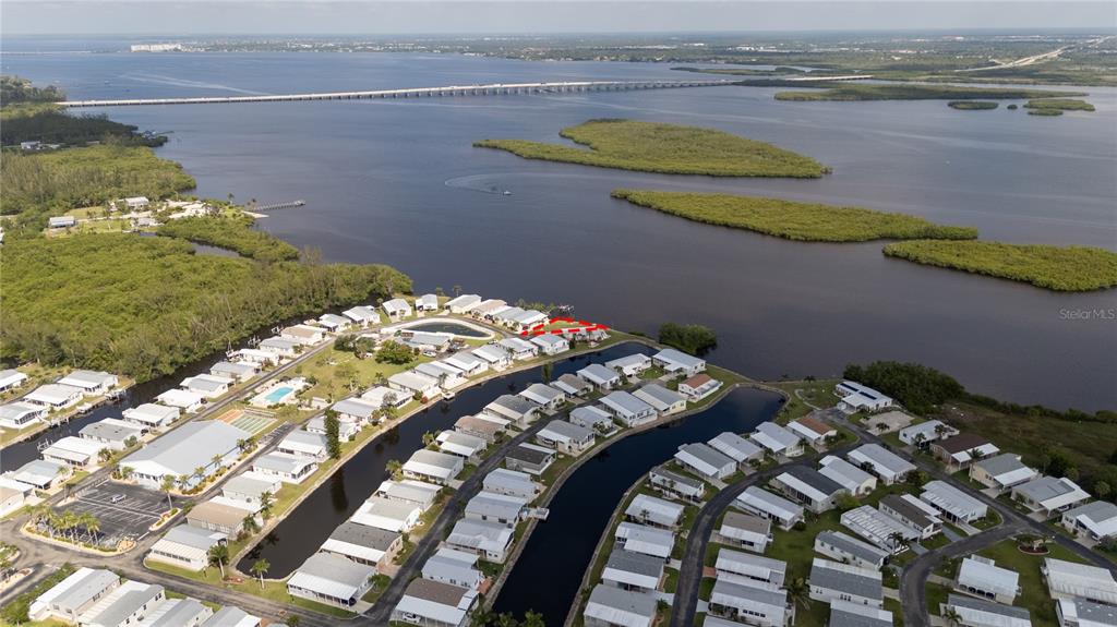 An aerial view shows a waterfront mobile home community with a highlighted property — 4300 RIVERSIDE DRIVE UNIT 114, PUNTA GORDA, FL
