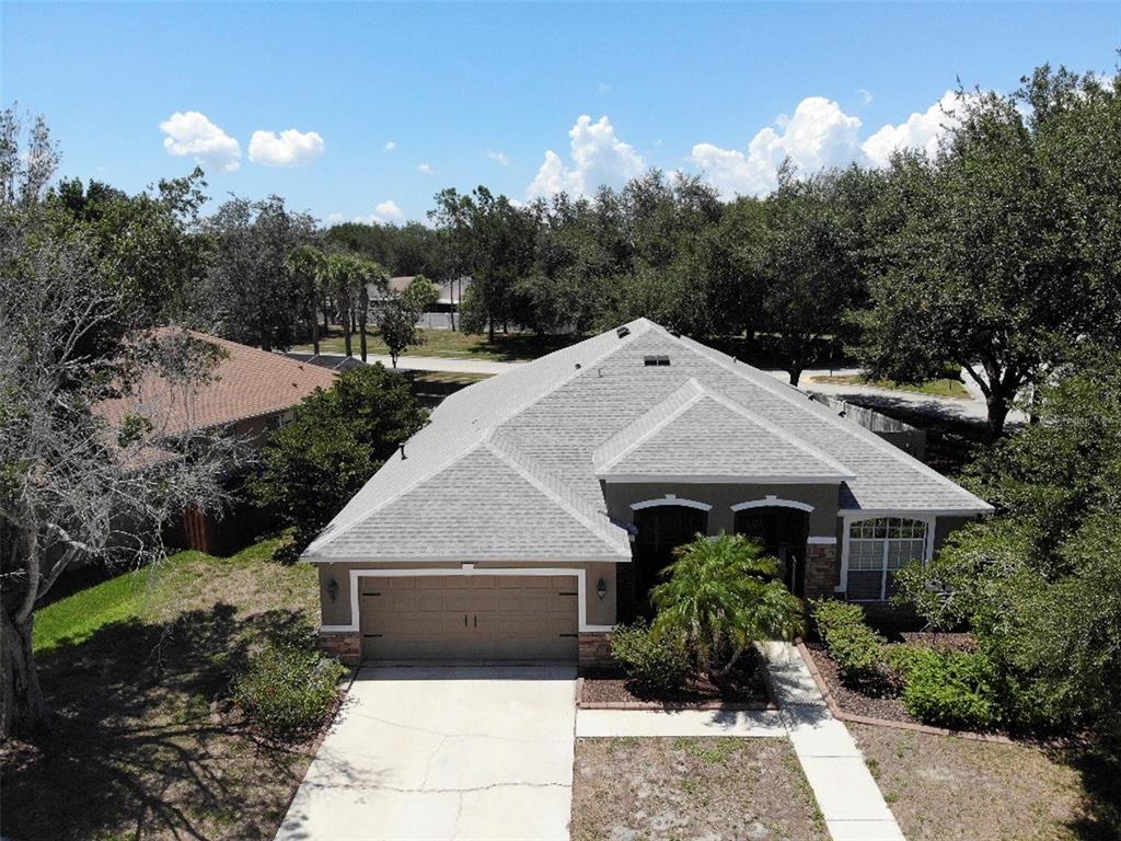 An aerial view of a single-story house with a gray roof and a two-car garage — 7605 NOTTINGHILL SKY DRIVE, APOLLO BEACH, FL