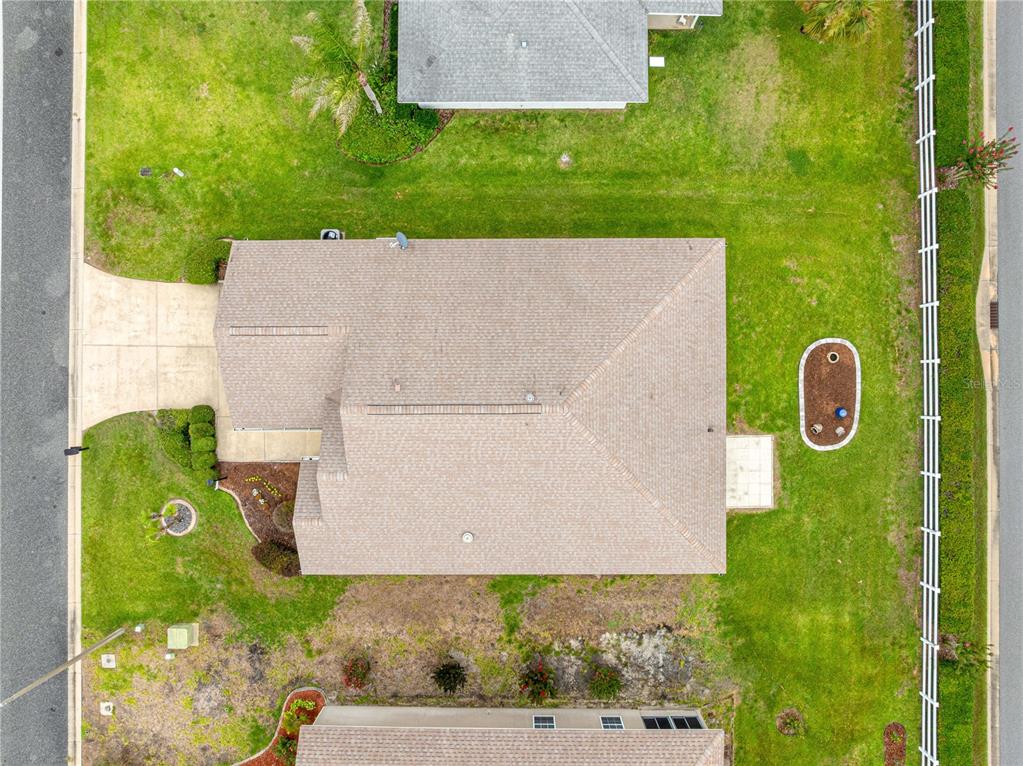 An aerial view shows a single-story house with a tan roof and a fenced backyard — 11137 SE 173RD PLACE, SUMMERFIELD, FL