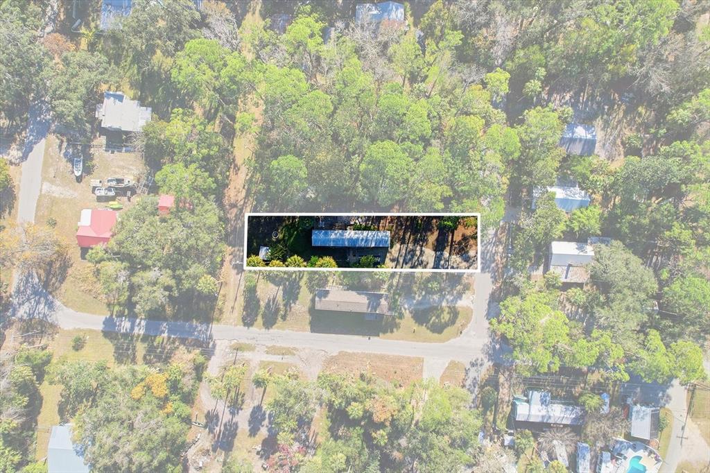 An aerial view shows a rectangular property highlighted among surrounding trees and residential structures — 24 62ND STREET, YANKEETOWN, FL