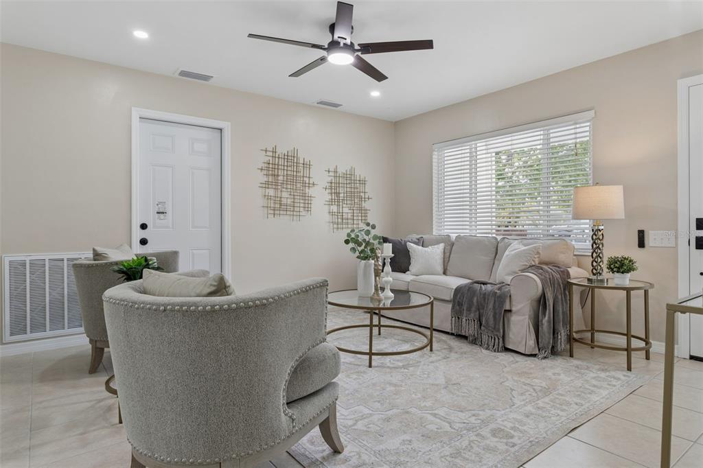 A living room features a sofa, two armchairs, a coffee table, and a ceiling fan — 10926 TEMPLE AVENUE, SEMINOLE, FL