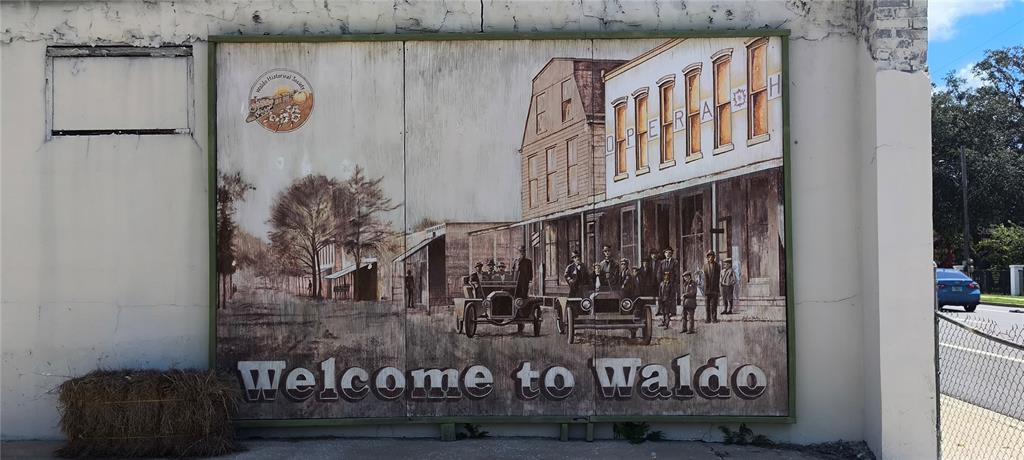 A large mural depicting a historic street scene is painted on the exterior of a building — 14610 KENNARD STREET, WALDO, FL