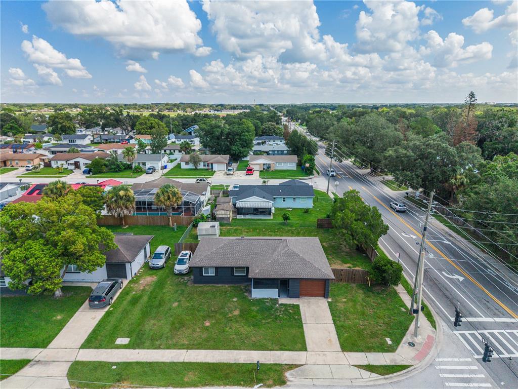 An aerial view shows a dark gray house with a brown roof and a large lawn — 2013 PATRICK STREET, KISSIMMEE, FL