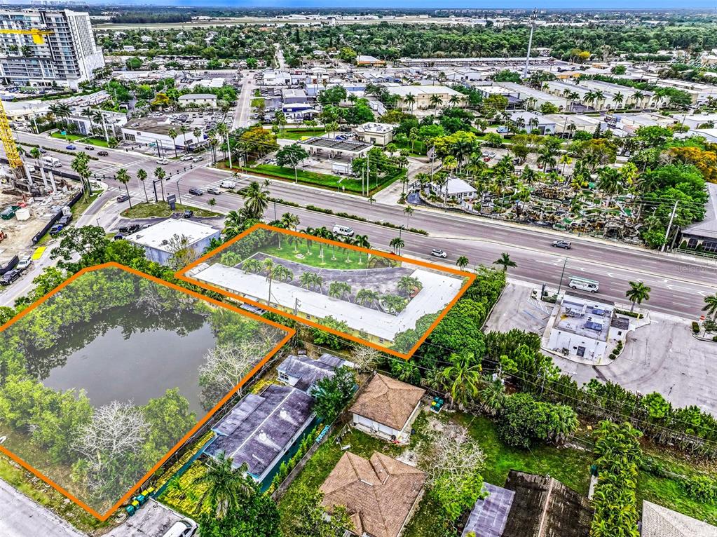 An aerial view shows two adjacent lots, one containing a pond and the other a building — 2164 TAMIAMI TRAIL E, NAPLES, FL