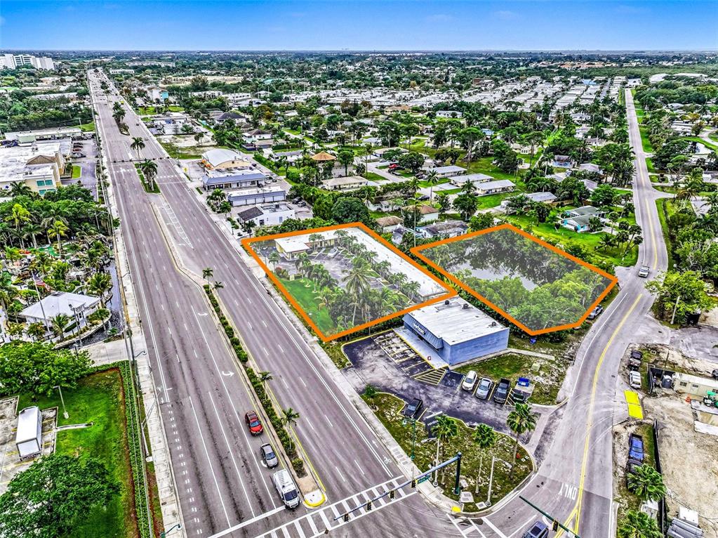 An aerial view shows two adjacent lots outlined in orange next to a multi-lane road — 2164 TAMIAMI TRAIL E, NAPLES, FL