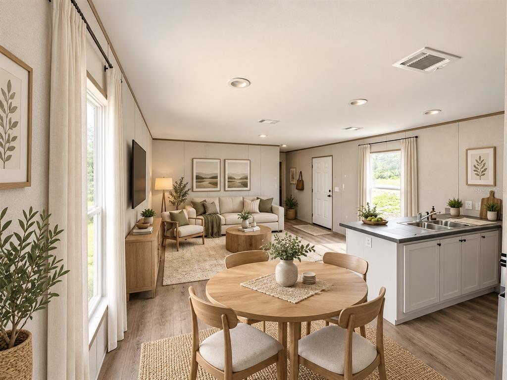 An empty room features light-colored paneled walls, wood-look flooring, a window, and a white door — 6470 NE 115TH AVENUE, WILLISTON, FL