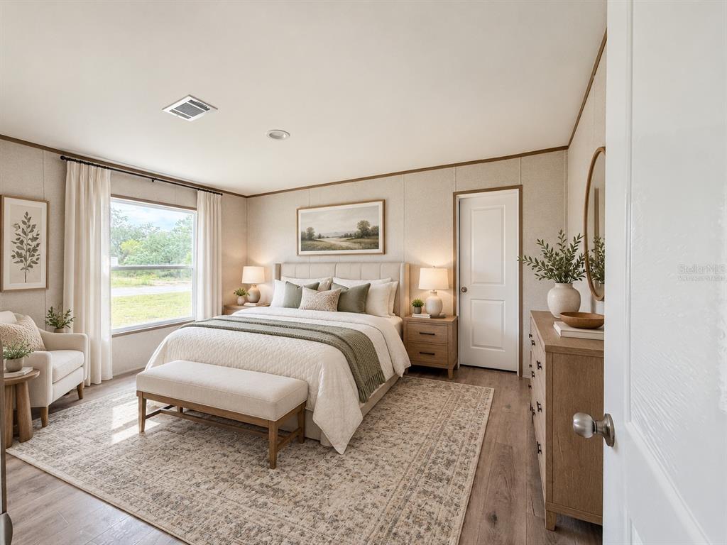 An open-concept kitchen and living area features wood-look flooring, recessed lighting, and a kitchen island — 6470 NE 115TH AVENUE, WILLISTON, FL