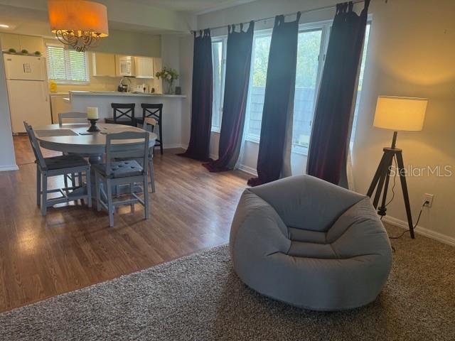 A dining area and living space feature a round table, chairs, and a beanbag chair — 1645 SPOONBILL LANE UNIT C, NAPLES, FL