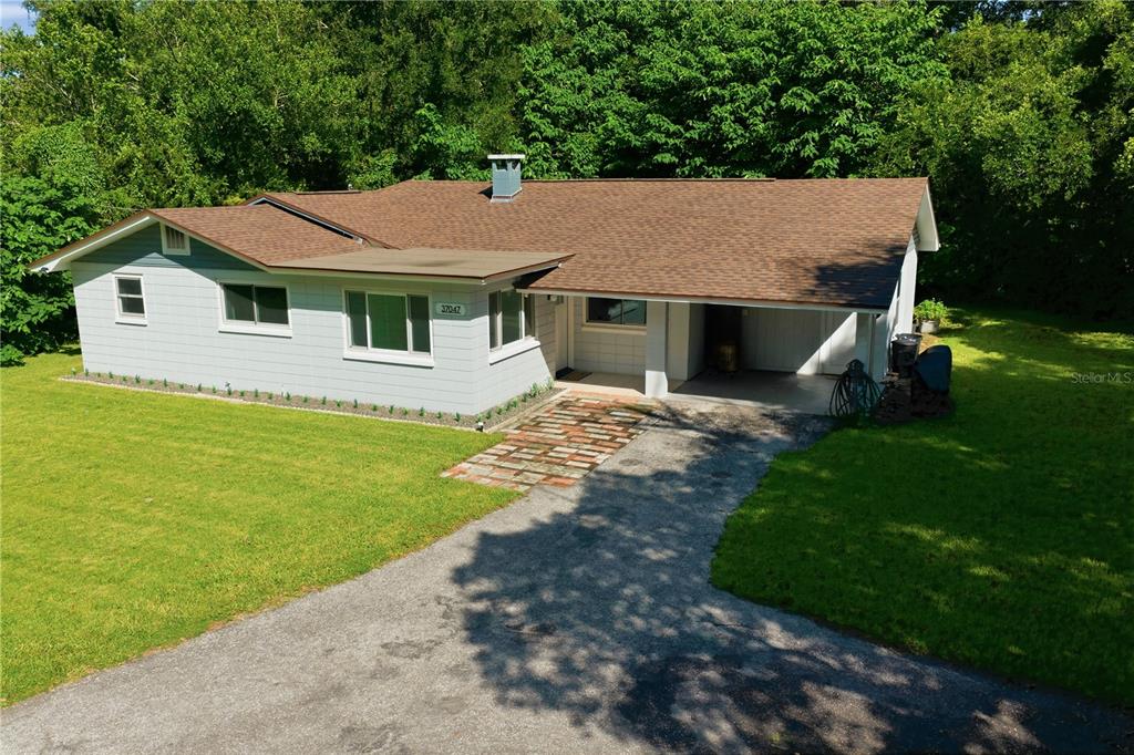 A single-story house with a light-colored exterior, brown roof, and a brick walkway — 37047 OLD SAN ANN ROAD, DADE CITY, FL
