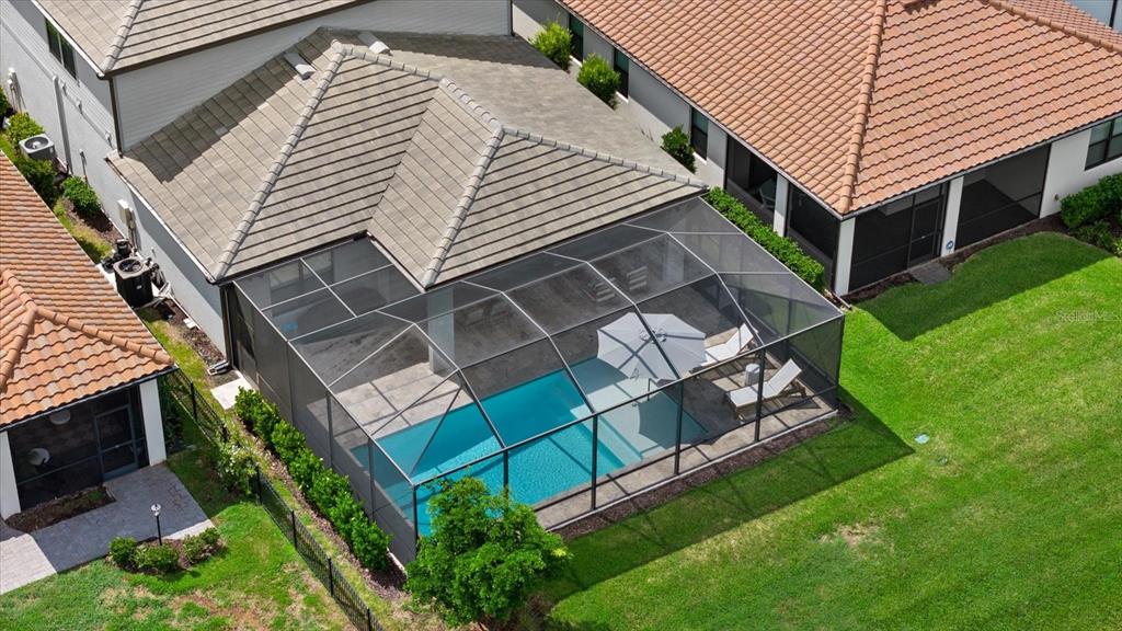 An aerial view of a house with a screened-in pool and patio in the backyard — 725 GADWALL COURT, BRADENTON, FL