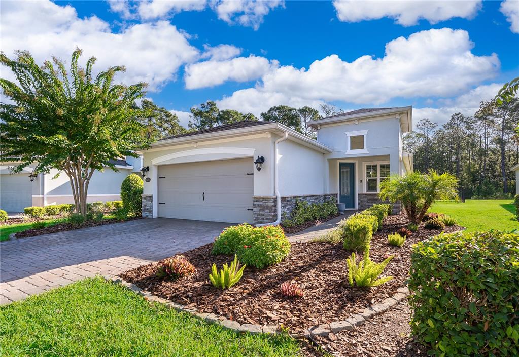 A single-story house with a garage, stone accents, and a landscaped front yard — 1309 HAYTON AVENUE, DELAND, FL