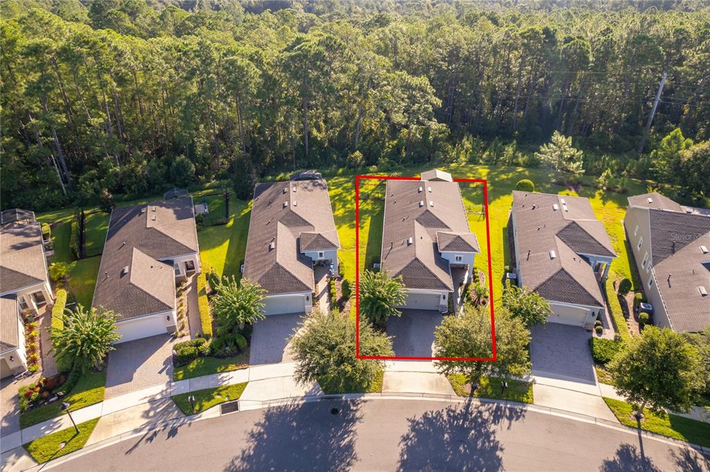 An aerial view shows a row of suburban houses with a red outline highlighting one — 1309 HAYTON AVENUE, DELAND, FL