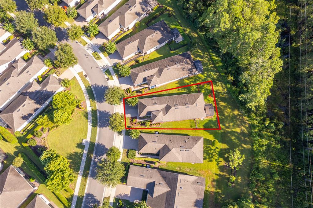 An aerial view shows a single-family home outlined in red within a suburban neighborhood — 1309 HAYTON AVENUE, DELAND, FL