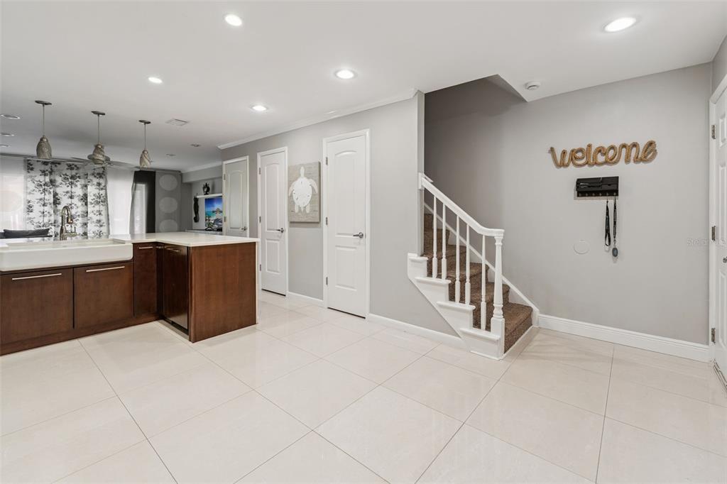 A modern kitchen features dark wood cabinets, stainless steel appliances, and a white quartz island — 4779 COQUINA KEY DRIVE SE, ST PETERSBURG, FL