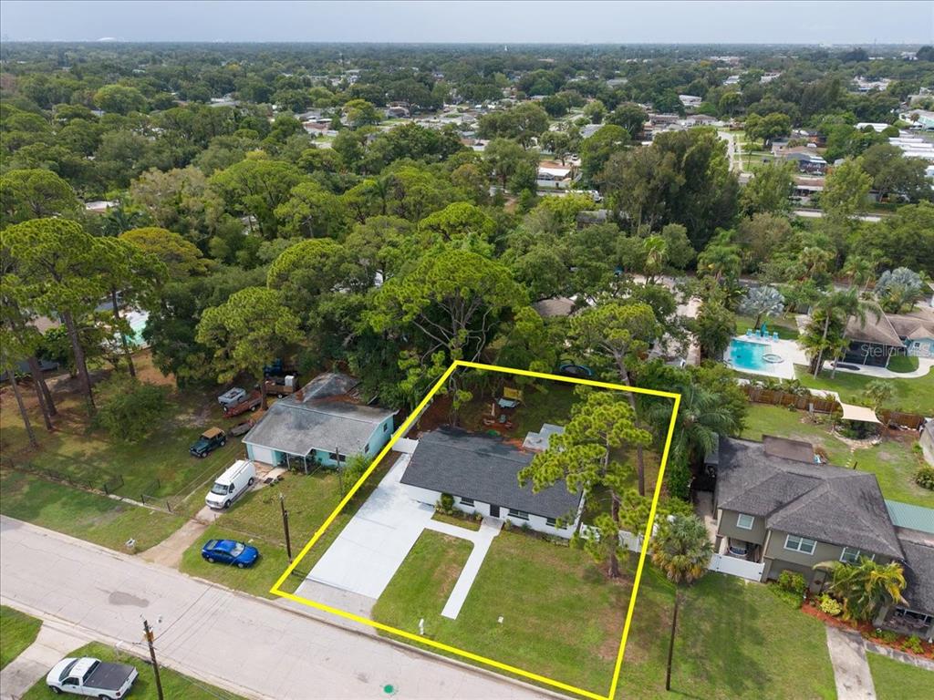 An aerial view of a single-story house with a large yard and a concrete driveway — 6350 60TH AVENUE N, ST PETERSBURG, FL