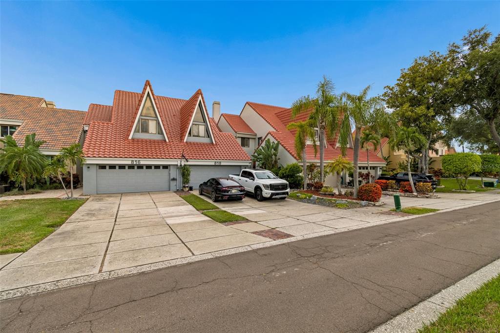 An aerial view shows a waterfront home with a private beach, gazebo, and boat docks — 820 SYMPHONY ISLES BOULEVARD, APOLLO BEACH, FL
