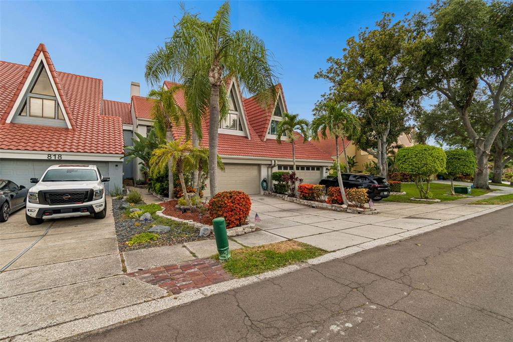 A two-story house with a red tile roof, palm trees, and a paved driveway — 820 SYMPHONY ISLES BOULEVARD, APOLLO BEACH, FL