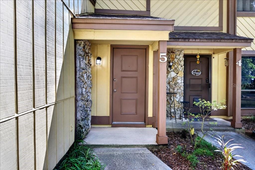 Two adjacent front doors with stone accents and house numbers on a residential building exterior — 5 GLEN ARBOR PARK, ORMOND BEACH, FL
