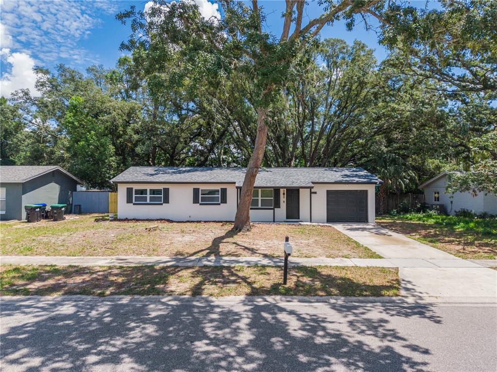A single-story house with a white exterior, dark shutters, and a front-loading garage — 3669 YOSEMITE DRIVE, ORLANDO, FL