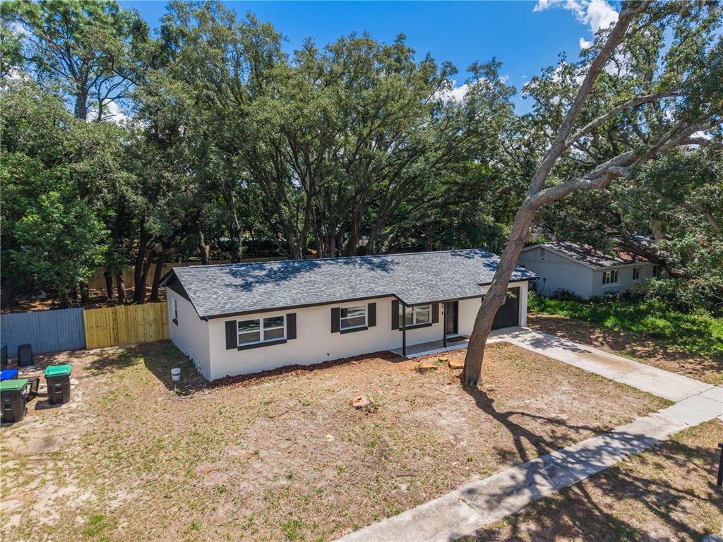 An aerial view of a single-story house with a gray roof and a concrete driveway — 3669 YOSEMITE DRIVE, ORLANDO, FL