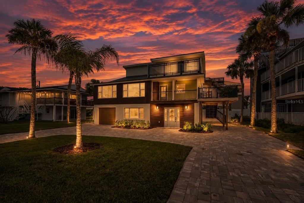 An elevated view of a waterfront area featuring palm trees, a truck, and a trailer — 830 EEL AVENUE, NEW SMYRNA BEACH, FL