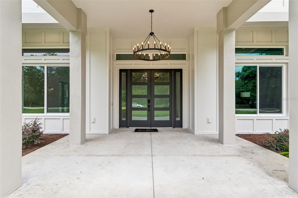 An aerial view of a two-story white house with a dark roof surrounded by trees — 12000 GOLDEN VALLEY DRIVE, NEW PORT RICHEY, FL